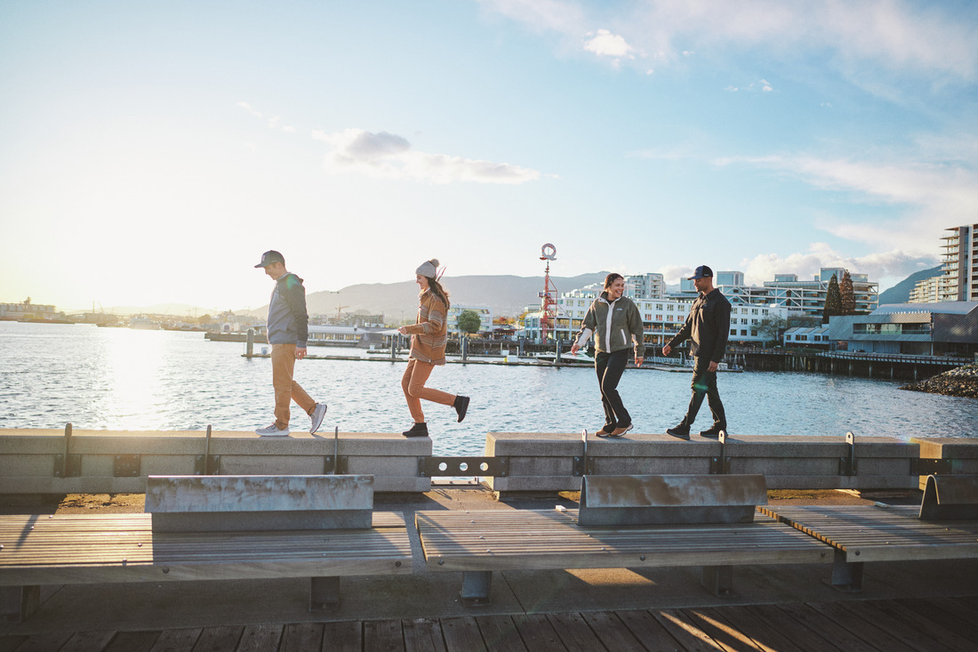 friends walk across a dock in columbia gear