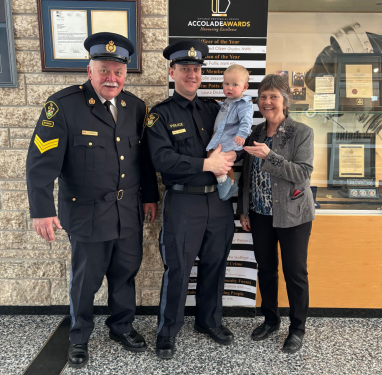 Jeff, Brenda, their son and grandson at the Provincial Police Academy graduation, where he walked without his walker to hand his son his badge.