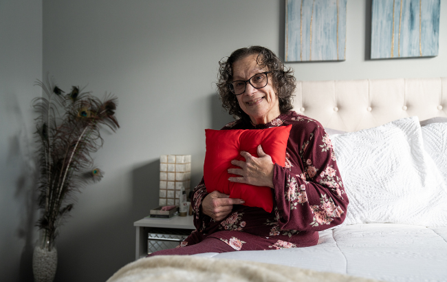 Mary Watts holding Heart Pillow