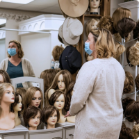 woman standing in wig shop