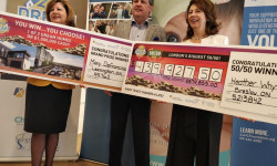 Dream Lottery presidents hold cheques