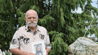 George Sutherland holding photo of Krystal Carder