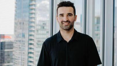 Nazen Kadri Smiling in front of a window