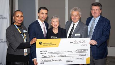 Andy &amp; Helen holding a check for one million dollars