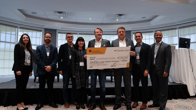 Kirk and Joanne Baines hold a giant cheque with doctors and LHSF CEO